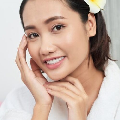 chest-up-shot-beautiful-asian-girl-touching-her-perfect-face-with-flower-her-hair_1098-19895